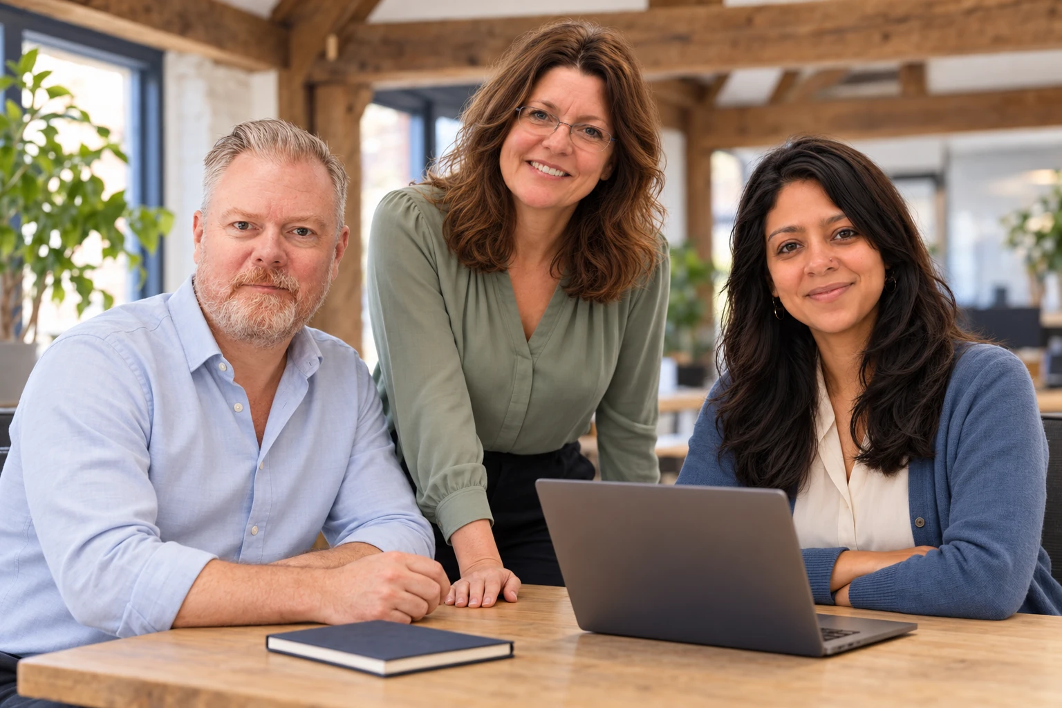 Jamie, Sarah and Priya, Email Blaster’s UK account managers, together at an office desk
